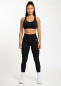 Woman in black high-waisted leggings and sports bra, fitness activewear for training and gym workouts