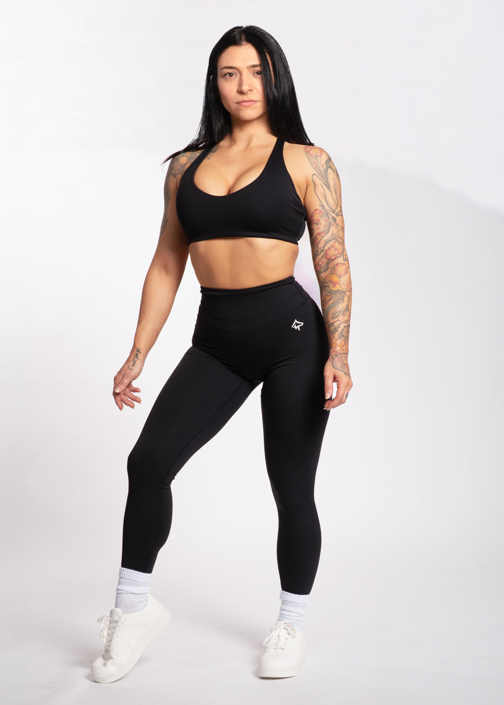 Woman in black high-waisted leggings and sports bra, fitness activewear for training and lifestyle