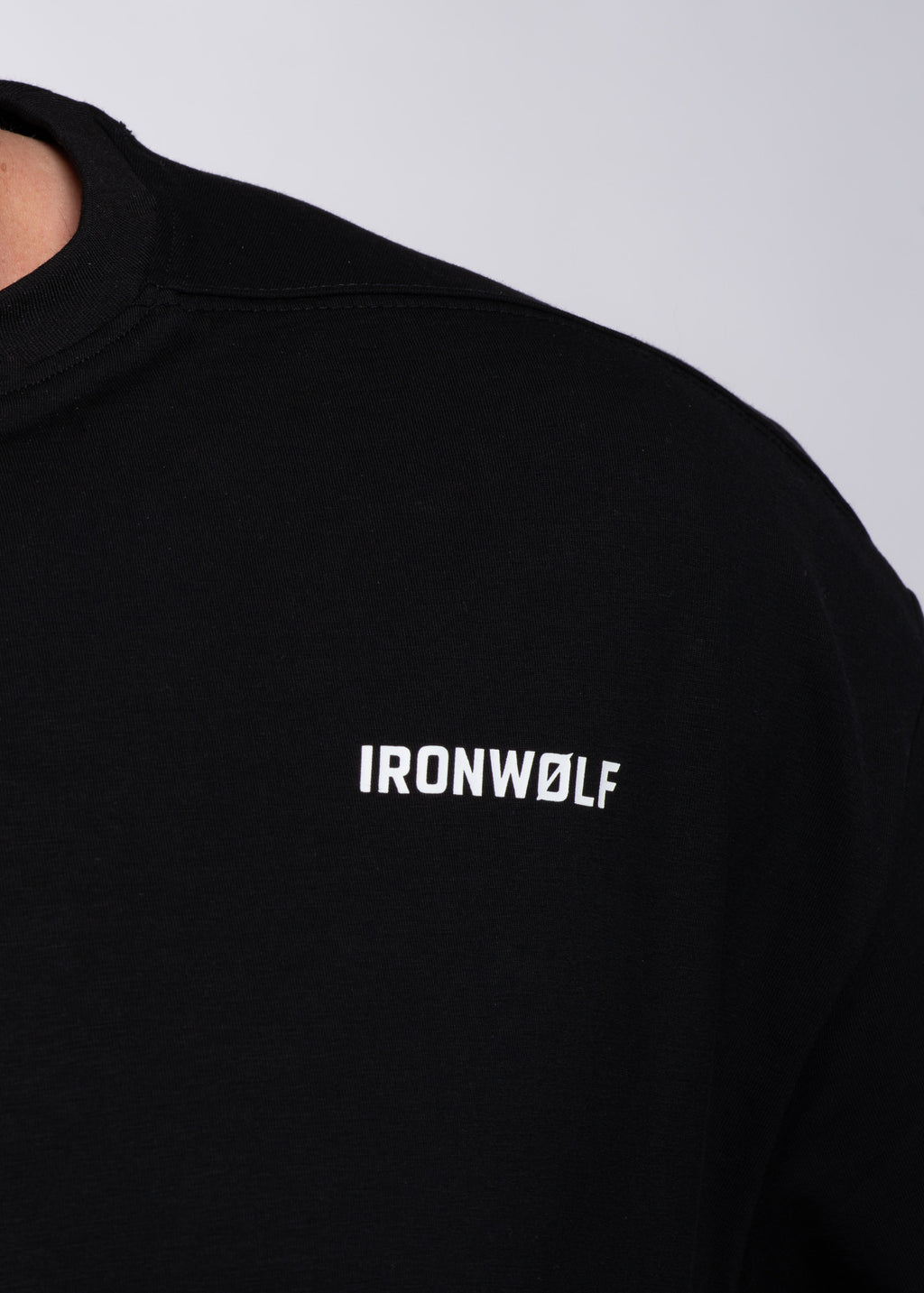 Black IRONWØLF gym tee with white logo, designed for training and active lifestyle comfort.