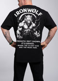 Man wearing black gym t-shirt with muscular wolf graphic and motivational quote for strength training
