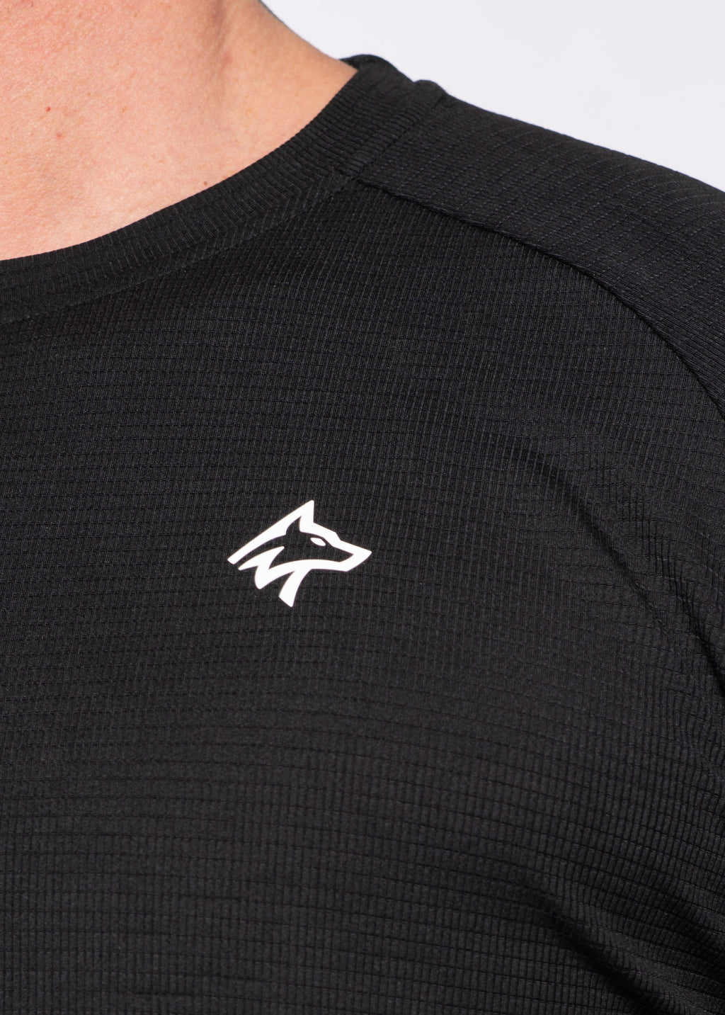 Black performance gym shirt with white wolf logo, ribbed texture for comfort and movement
