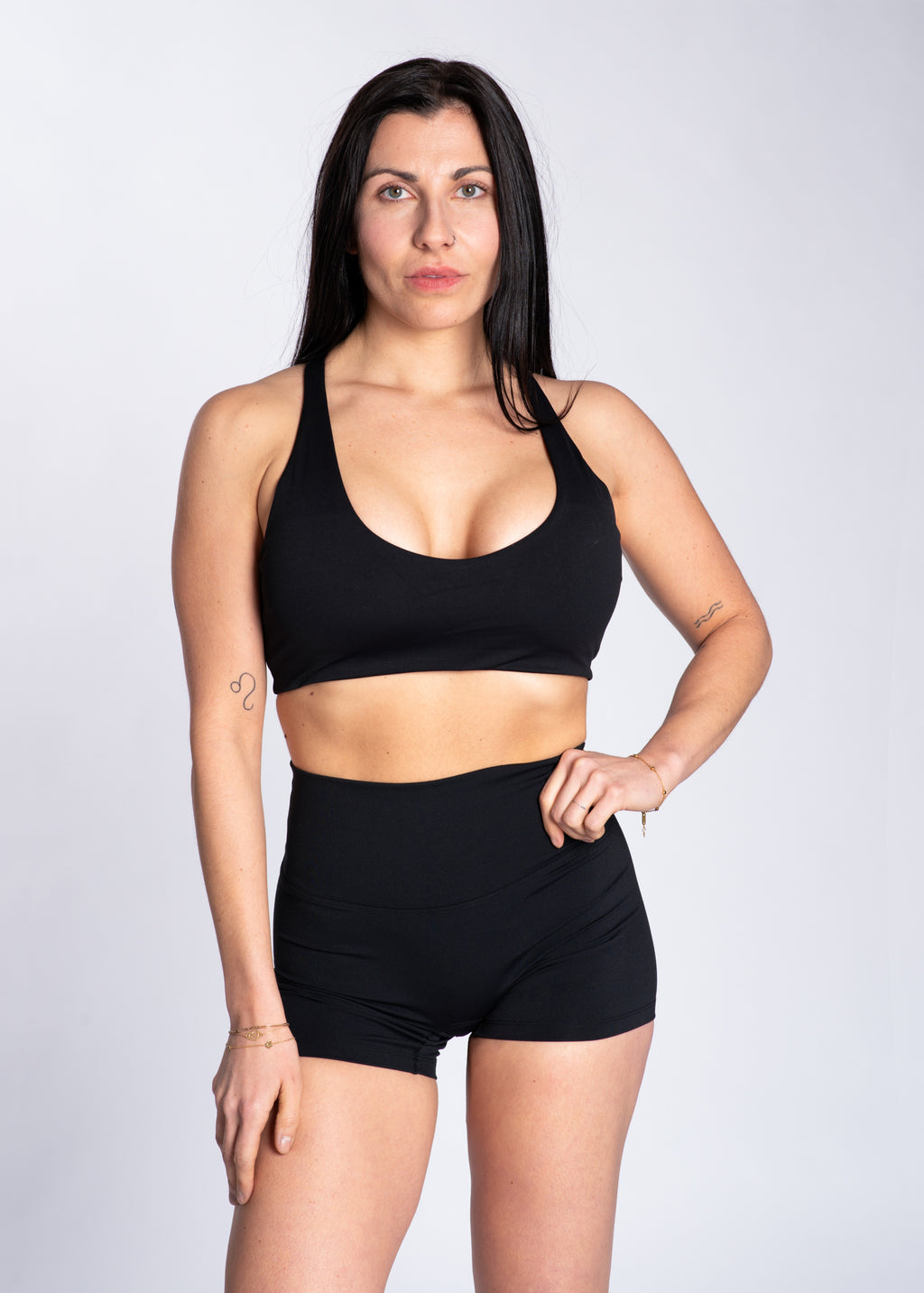 Woman in black high-waisted gym shorts and sports bra for training and active lifestyle