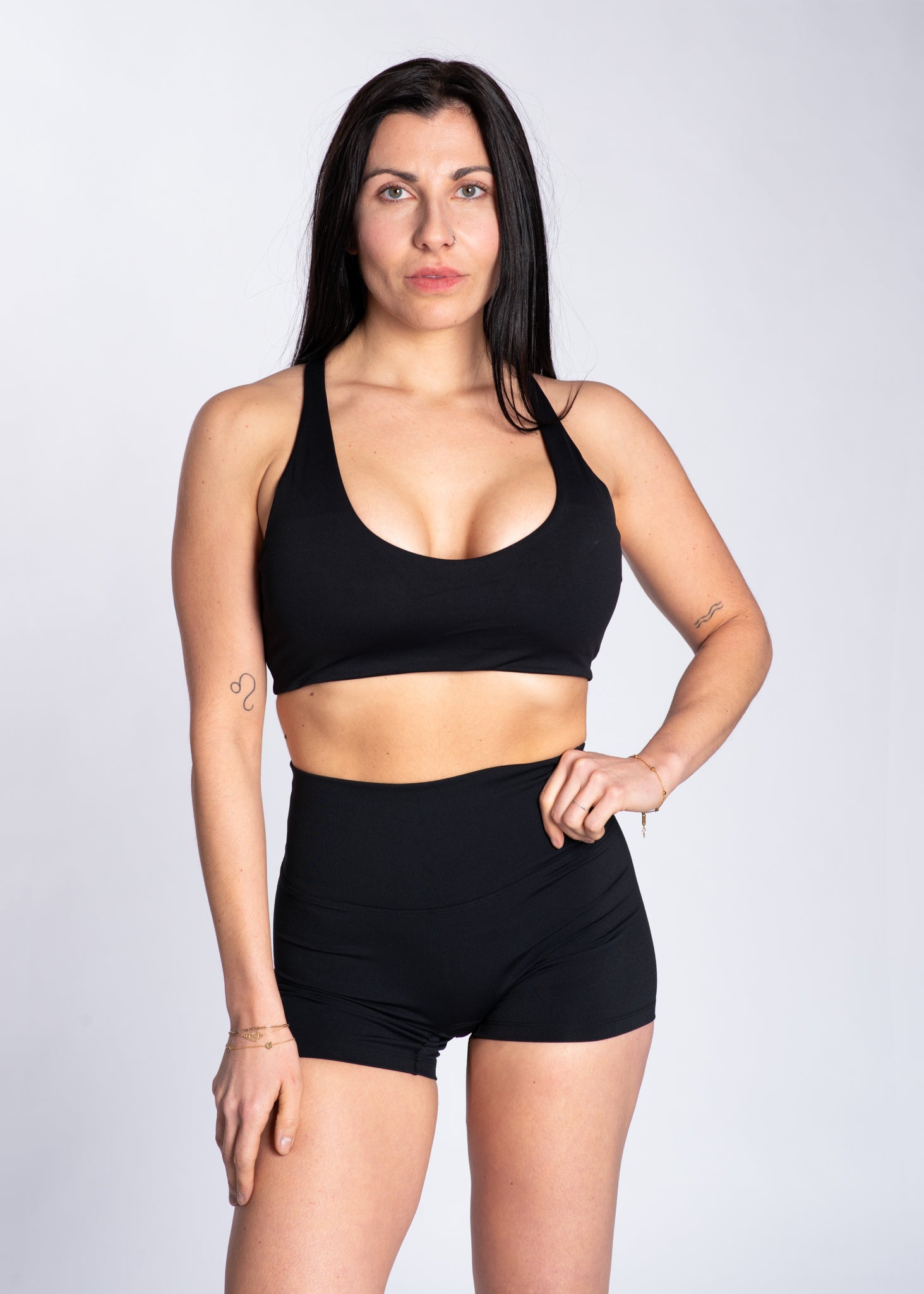 Woman in black high-waisted gym shorts and sports bra for training and active lifestyle