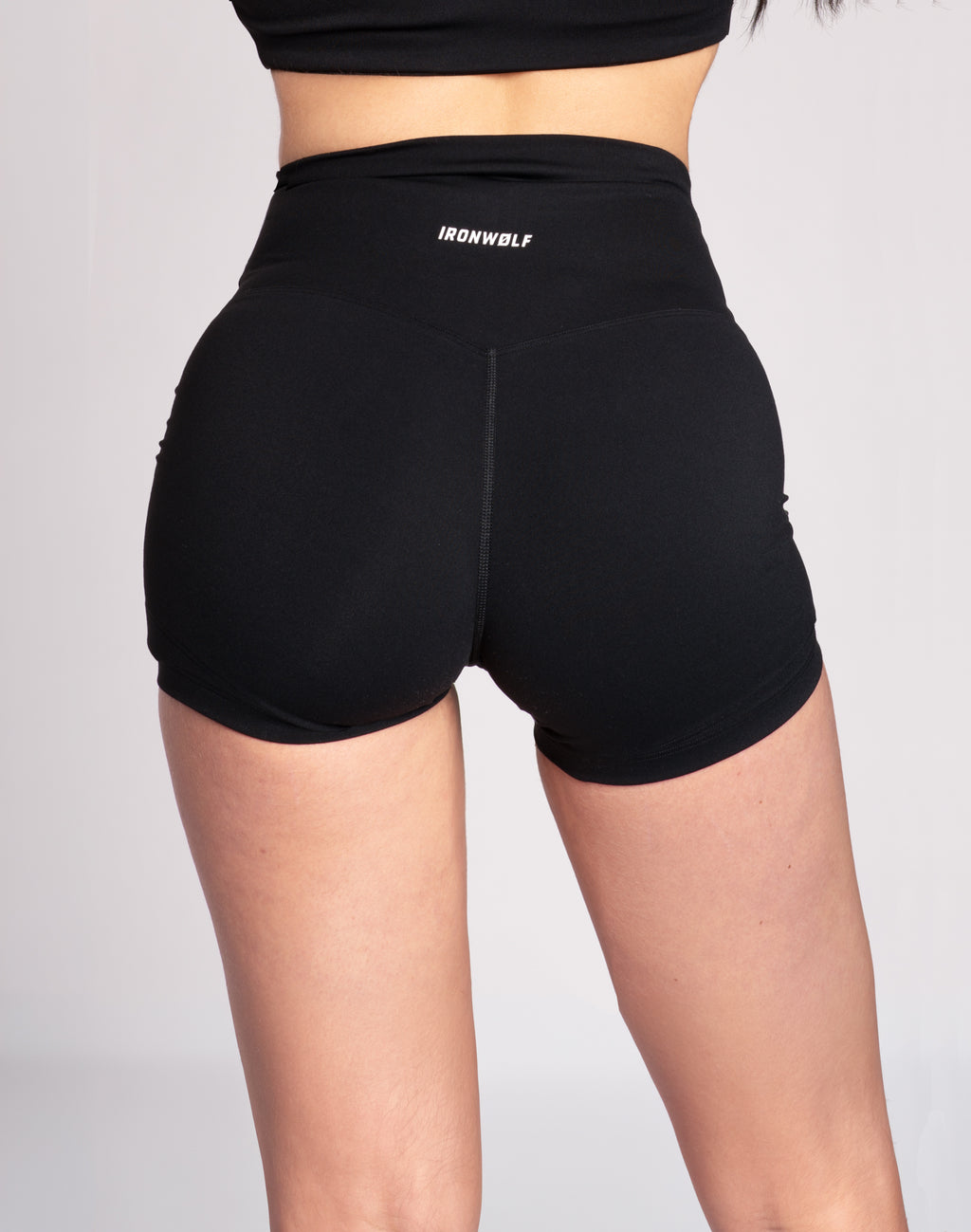 Black high-waisted gym shorts with IRONWØLF logo, designed for training and comfort