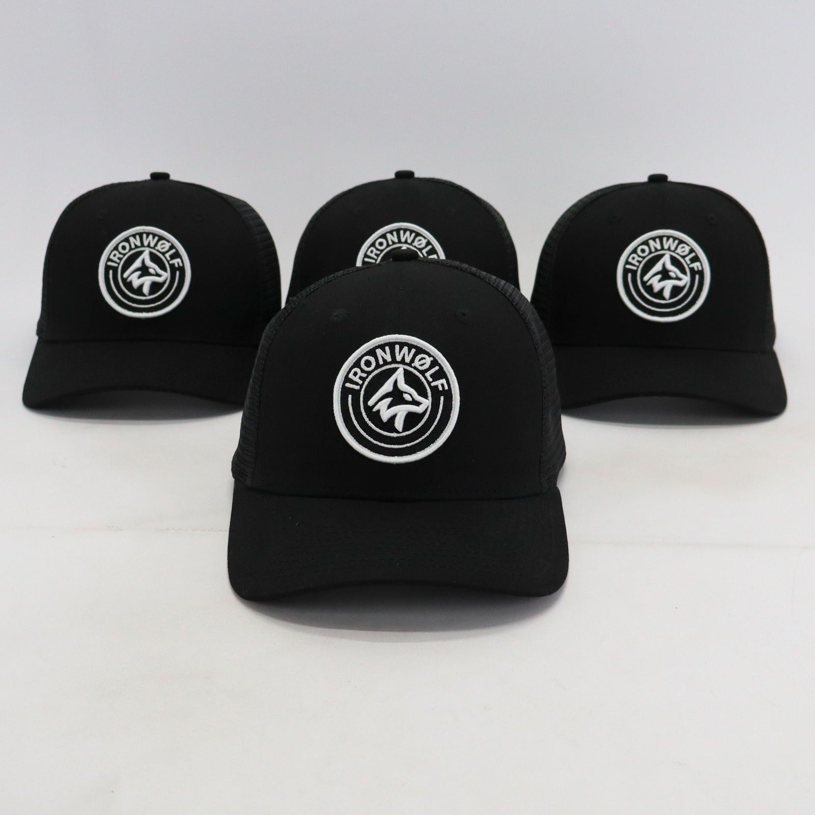 Black IRONWØLF trucker hats with white wolf logo, perfect for gym and active lifestyle wear