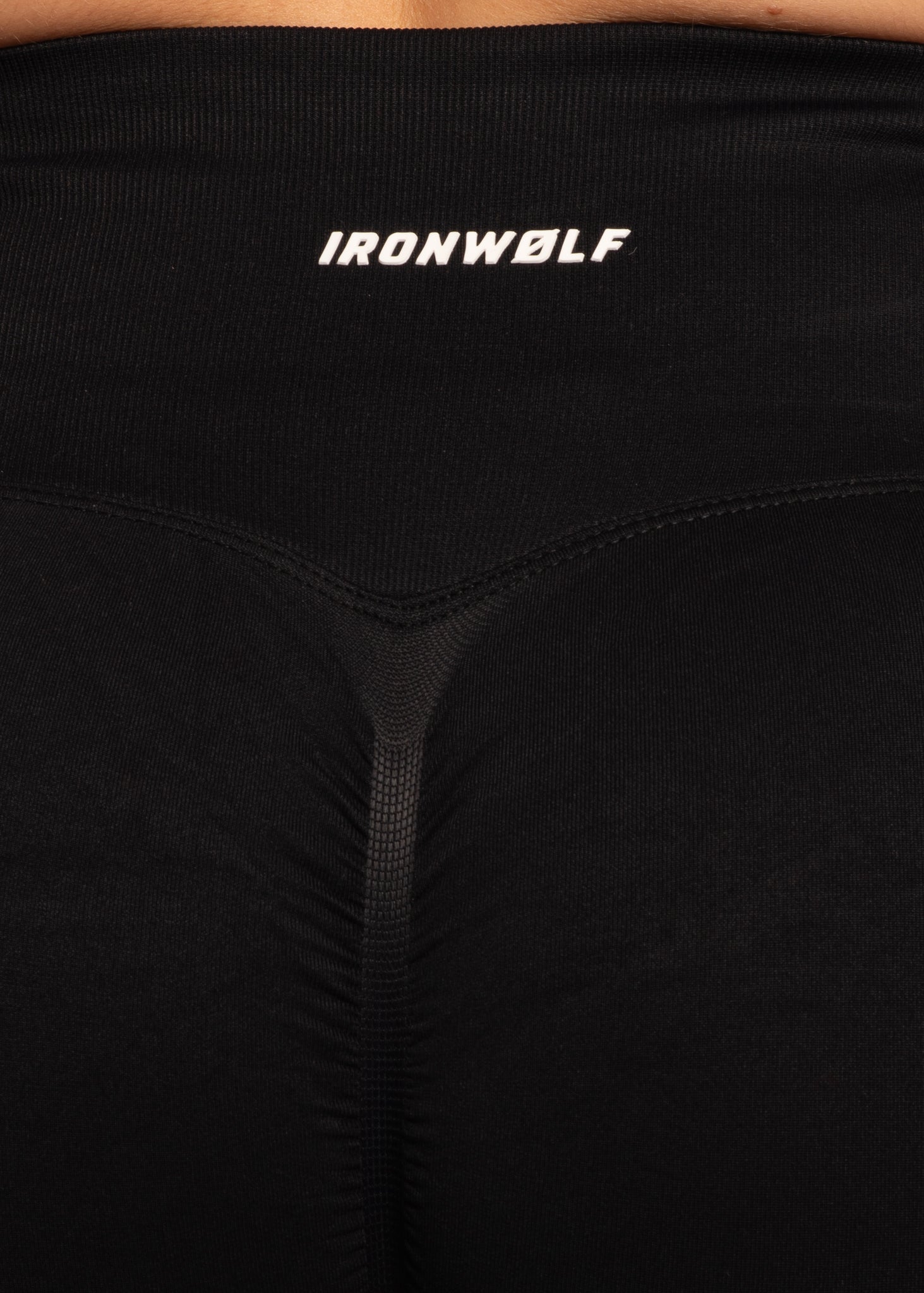 Black IRONWØLF gym leggings with white logo, high-waisted design for training and comfort