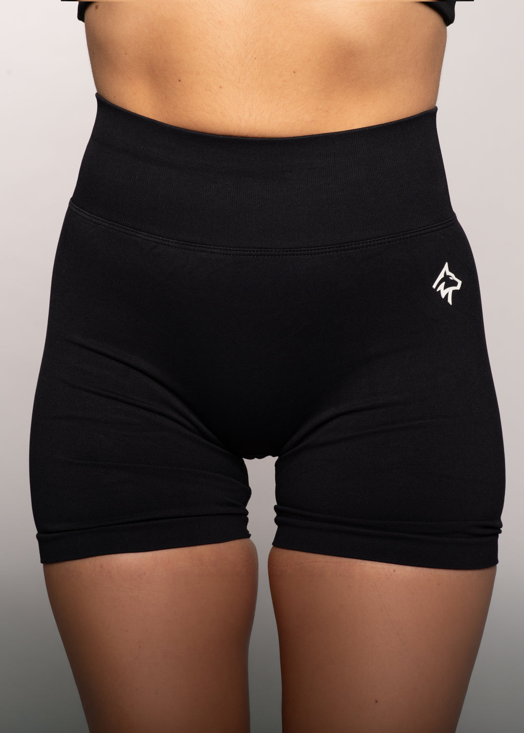Black high-waisted gym shorts with white wolf logo, designed for comfort and movement during workouts.
