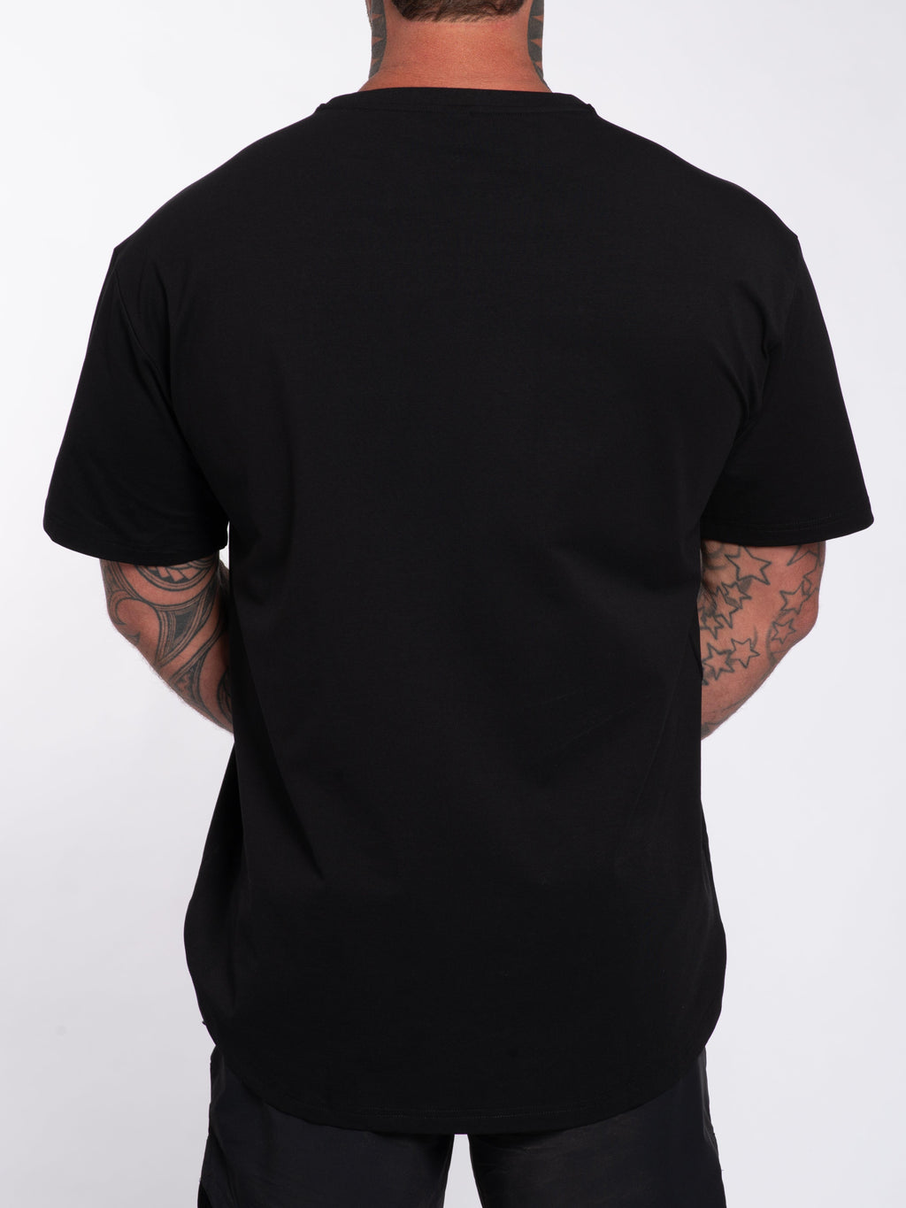 Man wearing black gym t-shirt with tattooed arms, back view for workout or casual wear