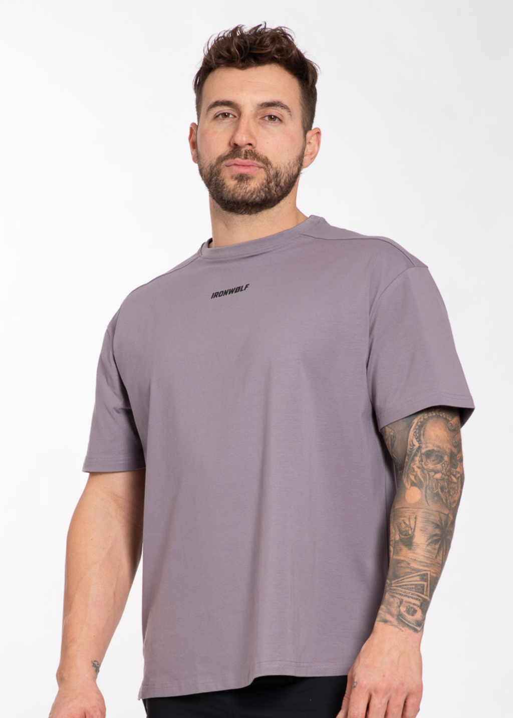 Man wearing gray IRONWØLF gym t-shirt with chest logo, ideal for training and active lifestyle