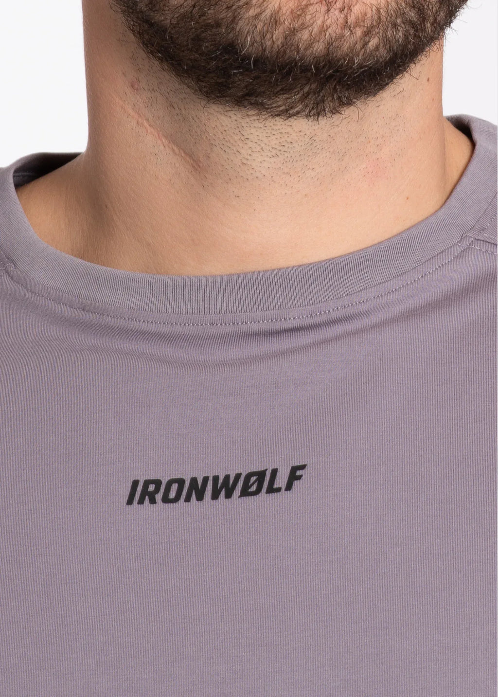 Man wearing gray IronWolf gym t-shirt with logo on chest, designed for training and comfort.