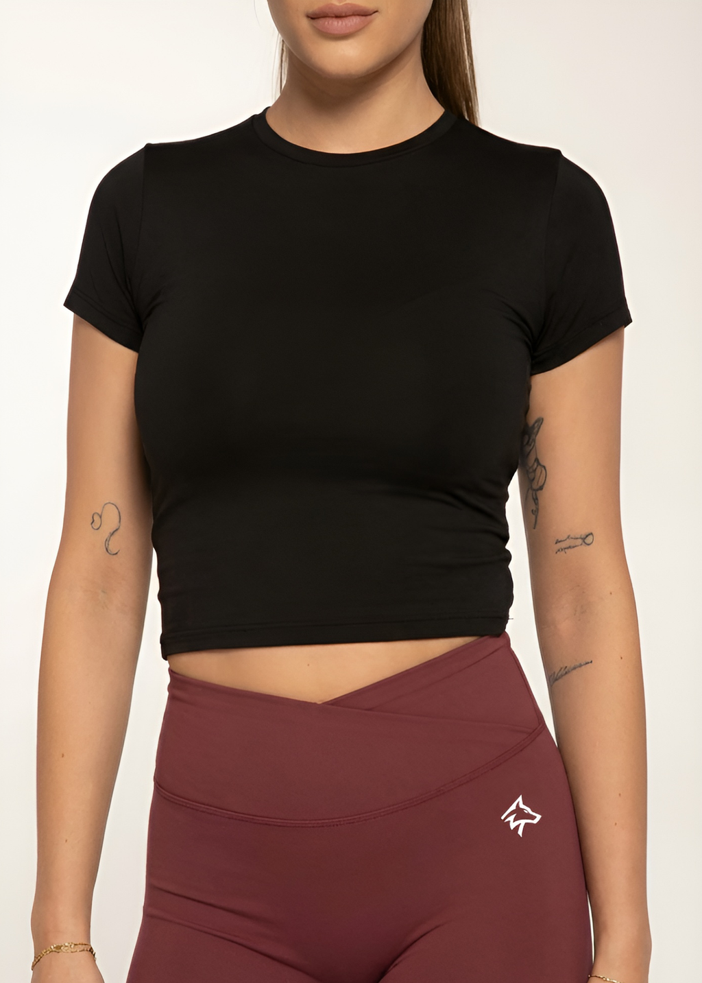 Black cropped gym top with burgundy wrap waist leggings, perfect for training and active lifestyle