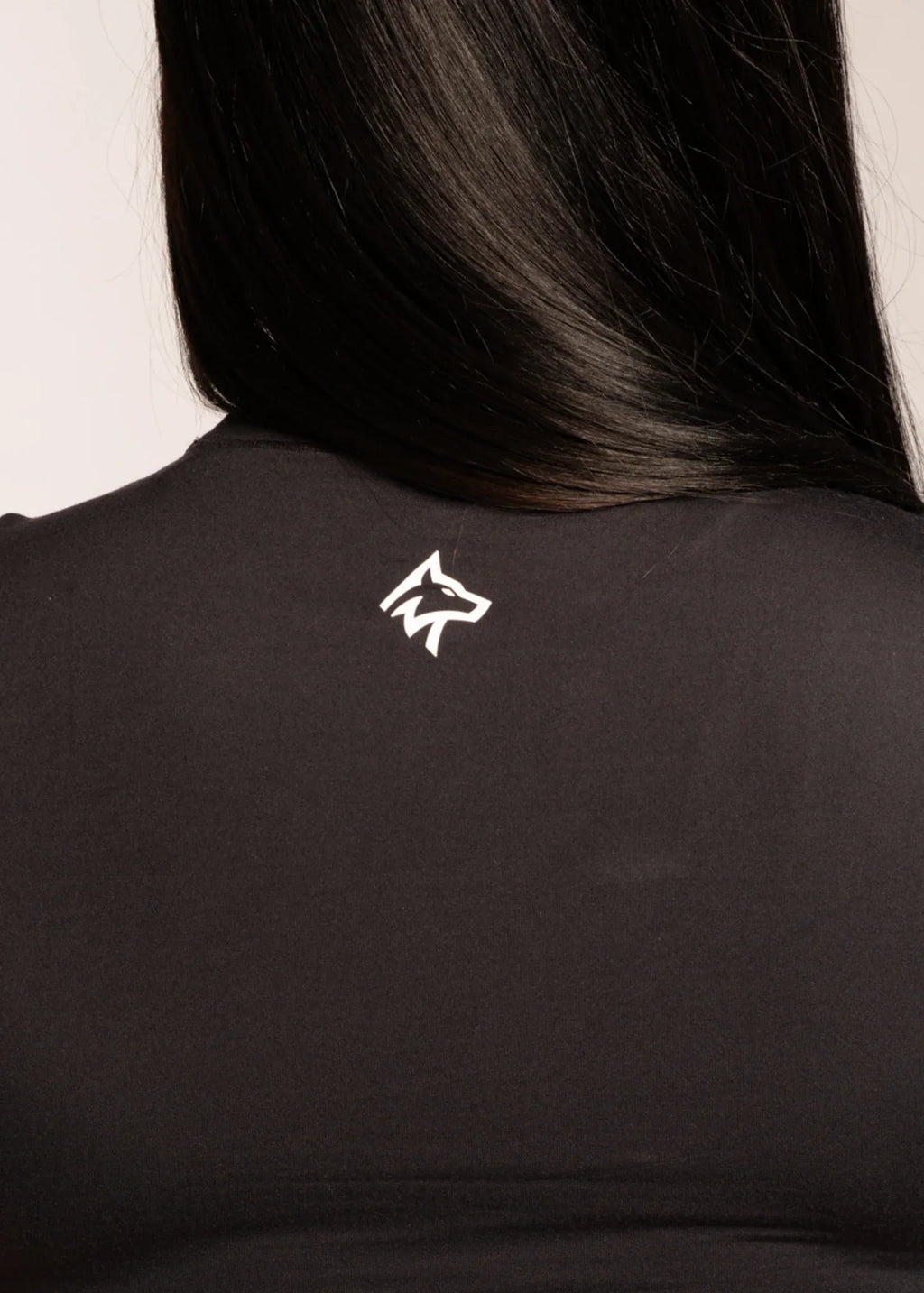 Black activewear top with white wolf logo on back, designed for gym and lifestyle wear