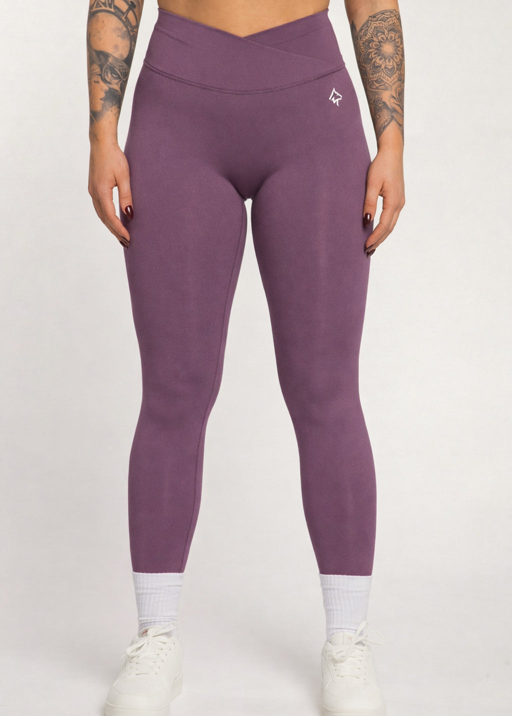 Purple high-waisted gym leggings with crossover waistband, ideal for training and active lifestyle