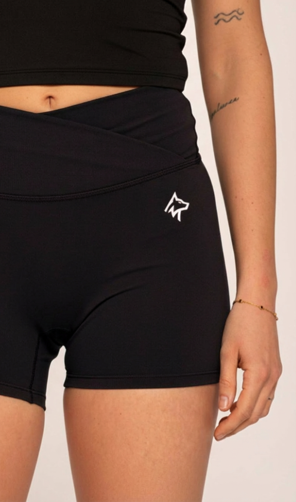 Black high-waisted activewear shorts with white wolf logo, designed for gym and training comfort.